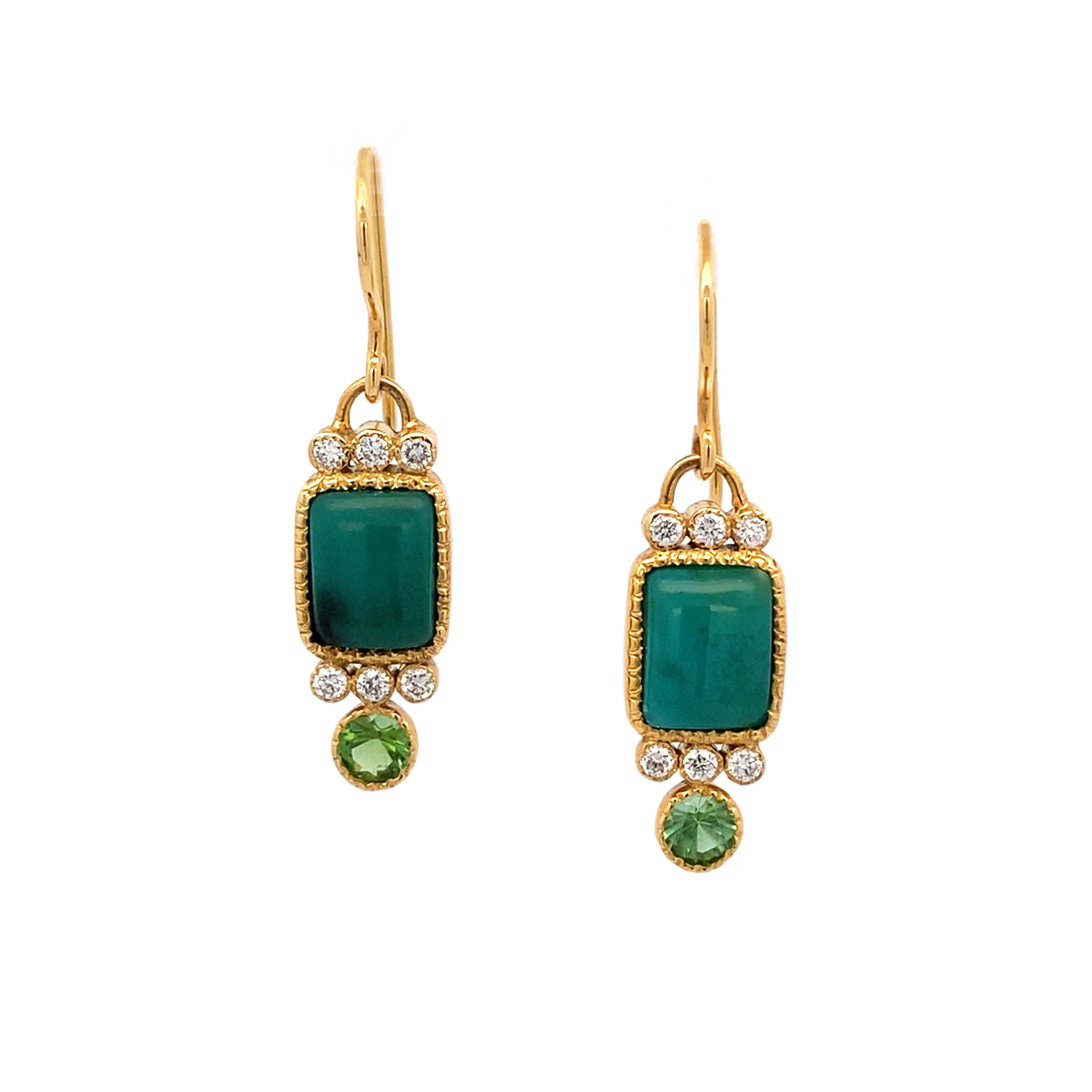 Gold earrings with green gemstones on a white background