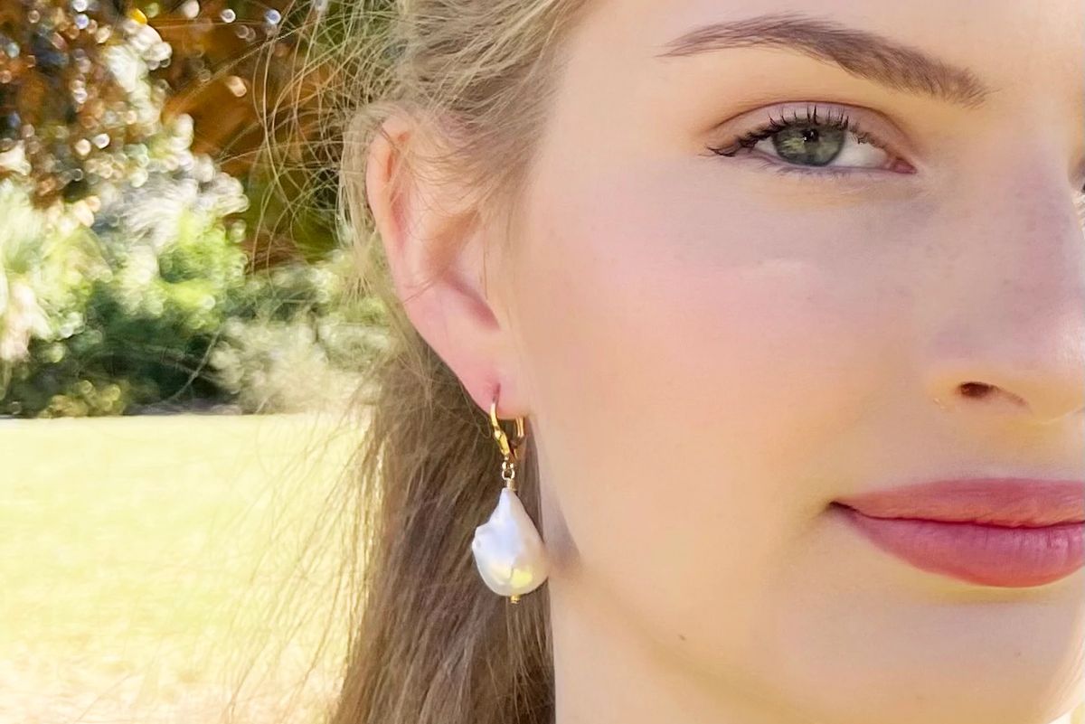 young woman wearing pearl earrings