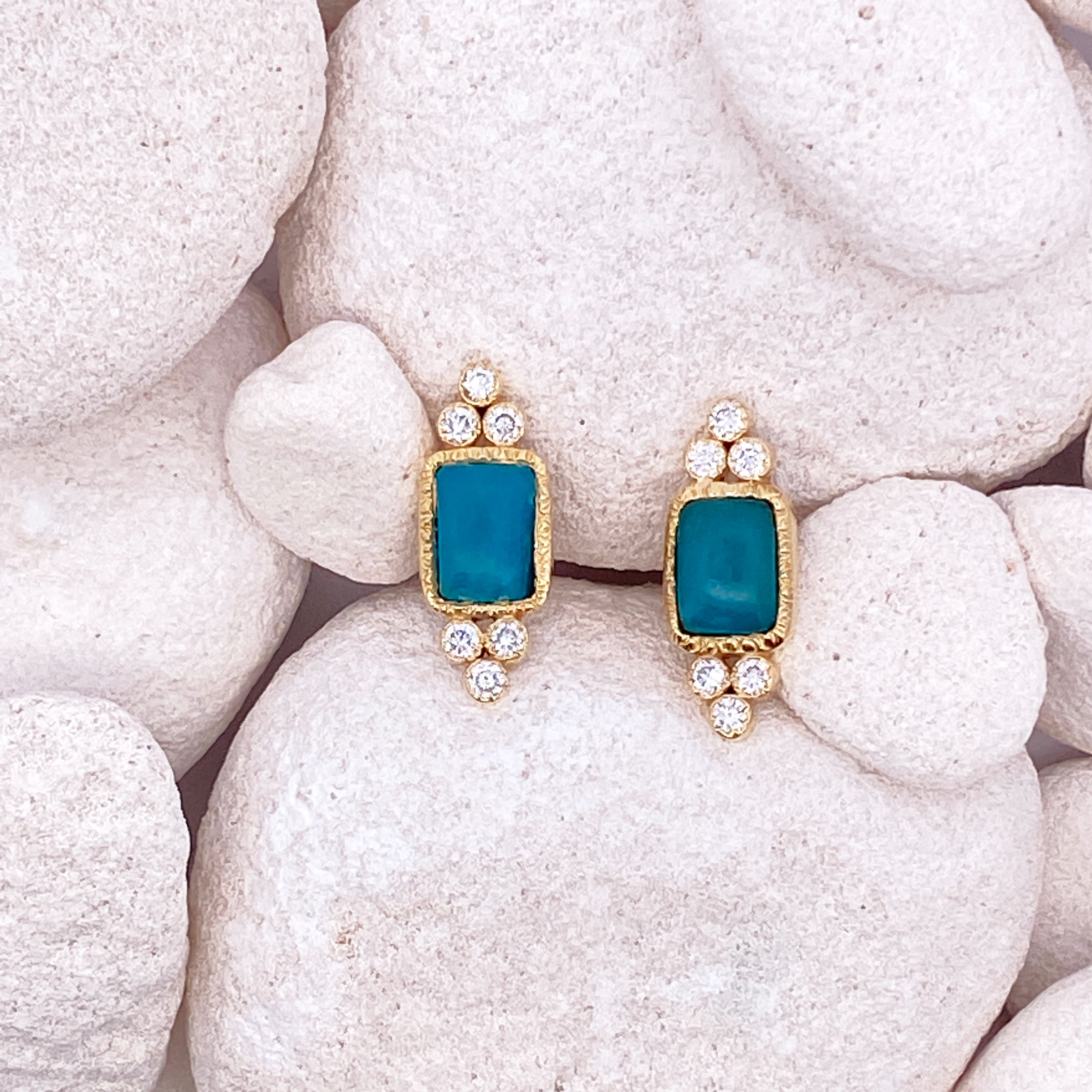 Pair of earrings on white stones