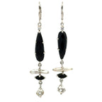 A pair of silver drop earrings featuring faceted black teardrop-shaped stones, a white stick pearl, a small black marquise stone, and clear crystal drops, shown against a plain white background.