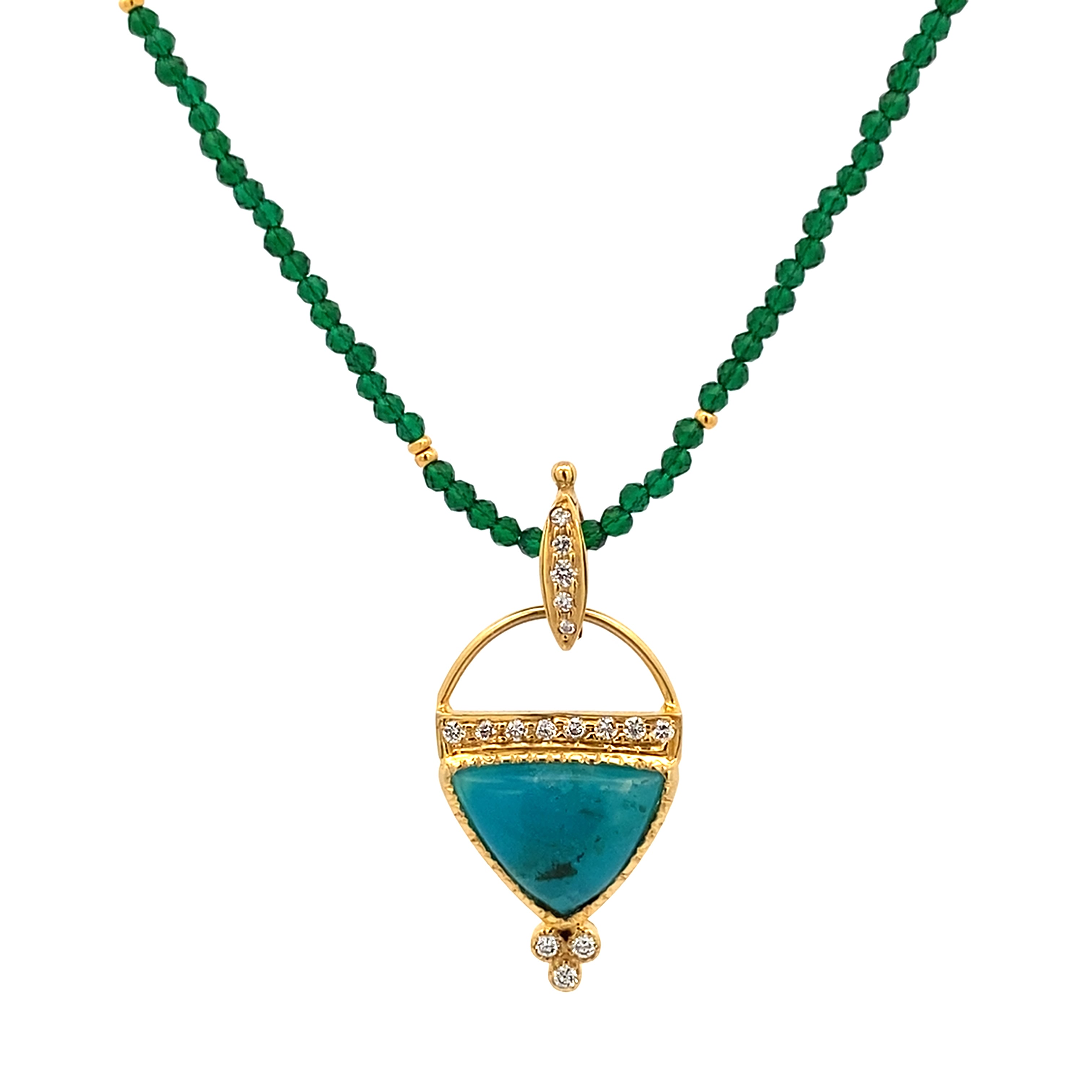 Gold pendant with a blue stone on a green beaded necklace against a white background