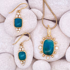 Gold jewelry set with blue stones on white stones