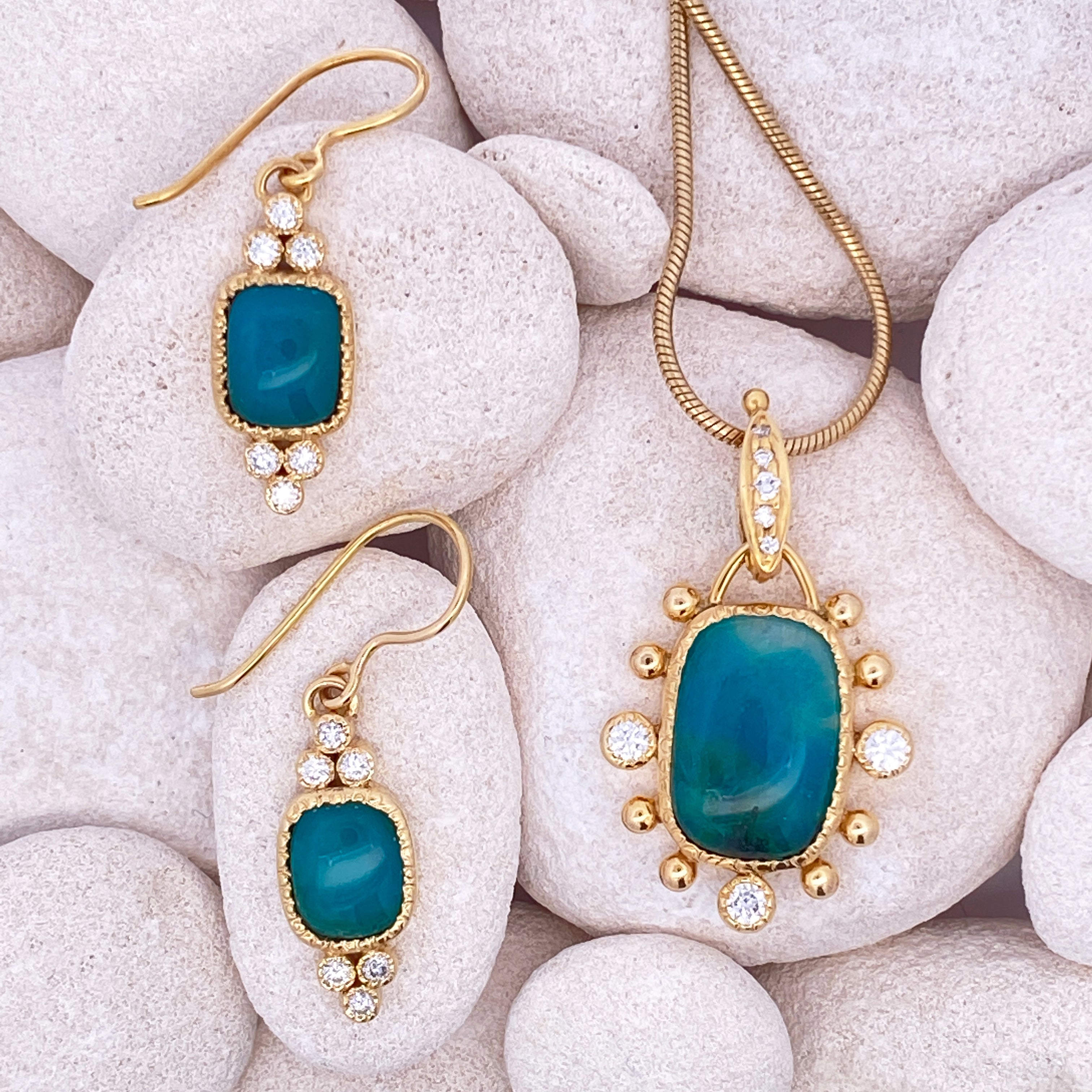 Gold jewelry set with blue stones on white stones