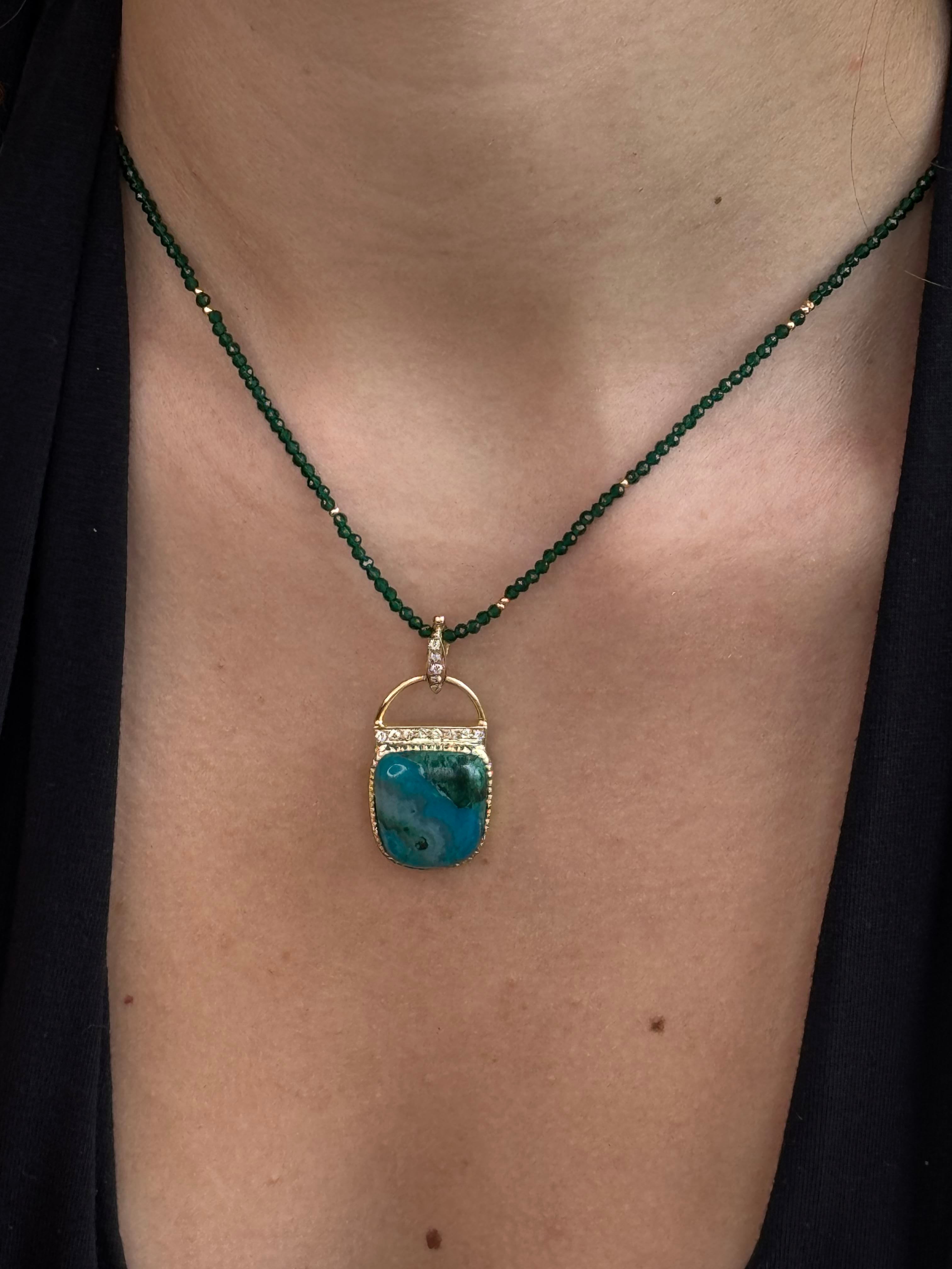 Necklace with a turquoise pendant on a person's neck against a dark background