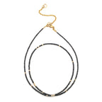 Black diamond beaded necklace with gold clasp on a white background