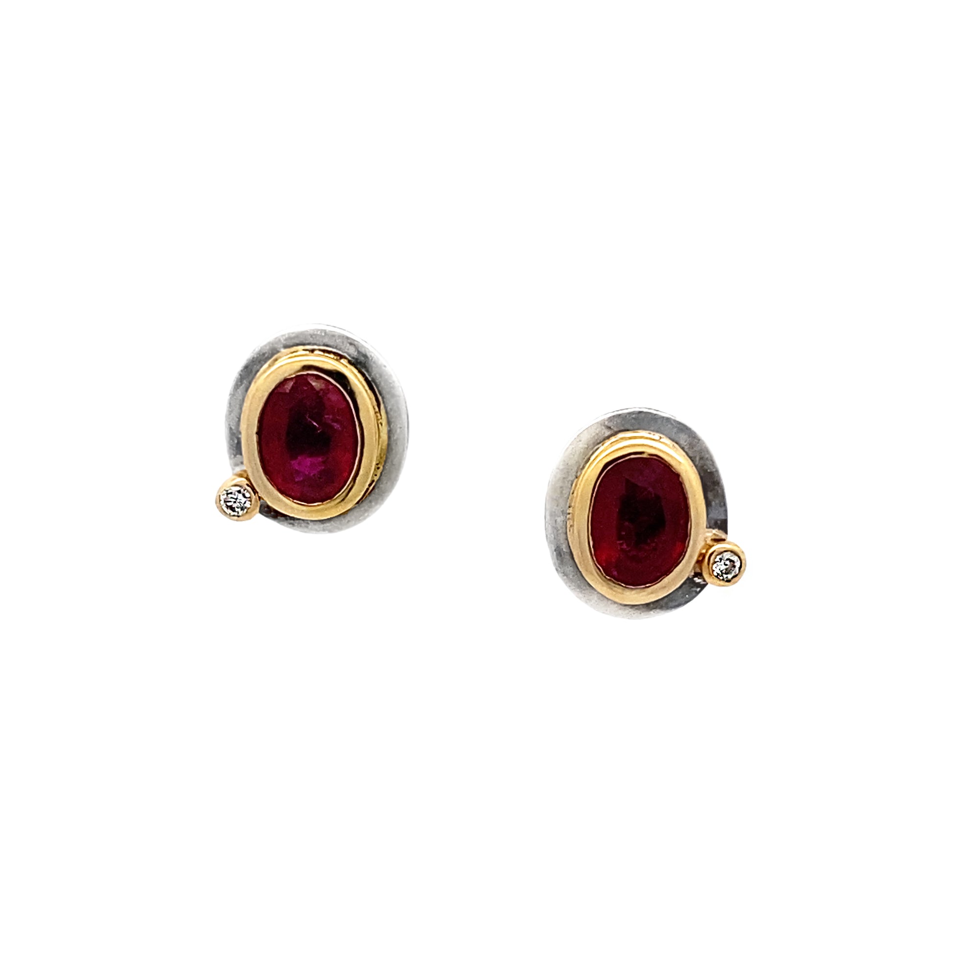 Pair of earrings with red gemstones and gold accents on a white background