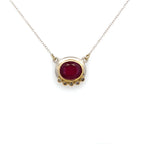 Necklace with a red gemstone pendant on a white background