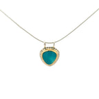 A silver and gold necklace with a gem silica chrysocolla pendant shown against a plain white background.