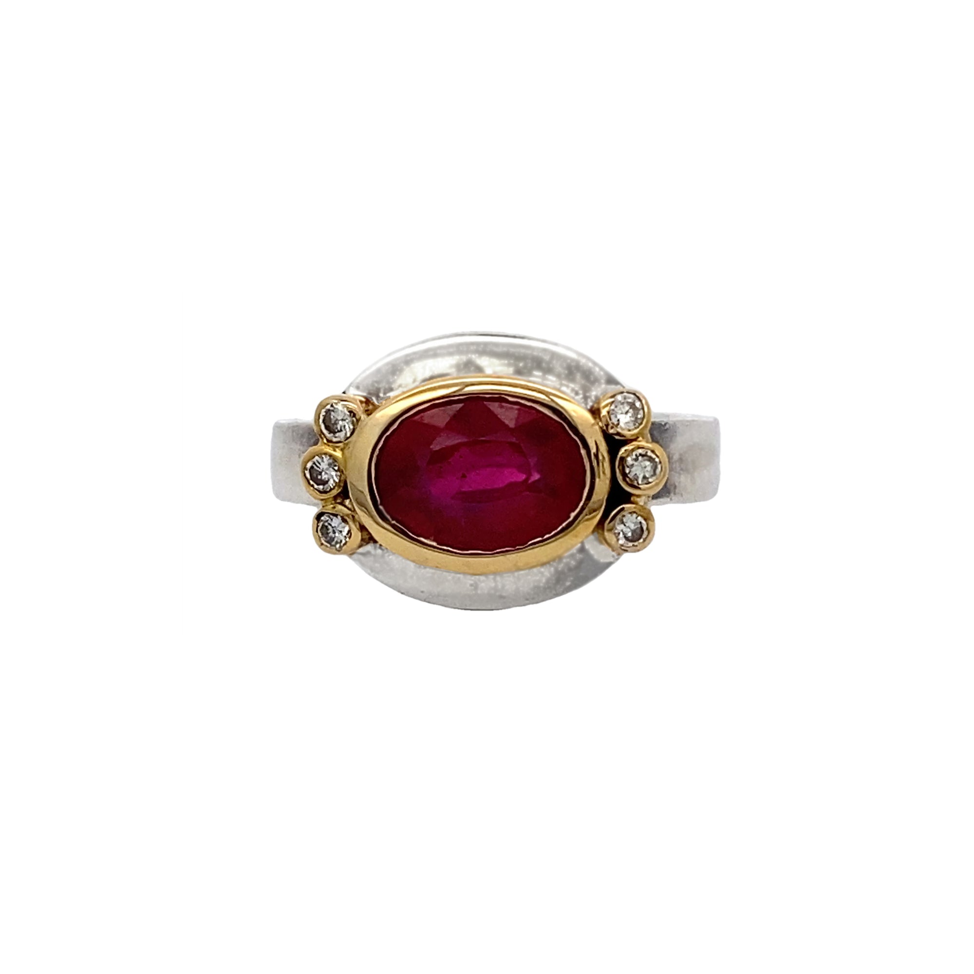 Ring with a red gemstone and gold and silver accents on a white background