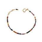 A gold gemstone bracelet with faceted Spinel, Hessonite, and Ruby beads, featuring an 18k vermeil clasp.